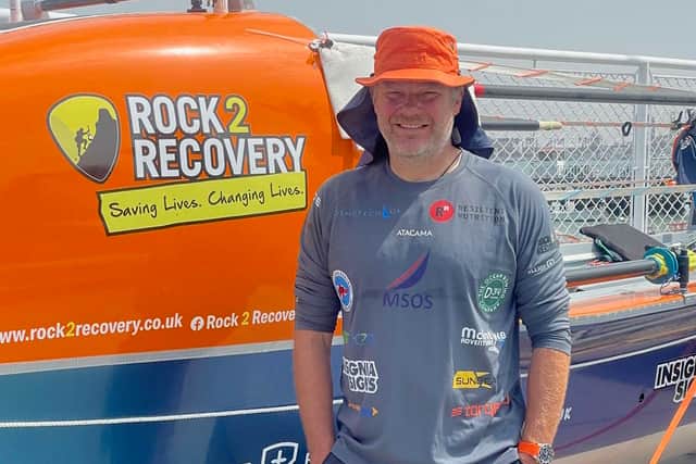 Dave 'Dinger' Bell next to his boat 'Billy No Mates' during his historic solo ocean row