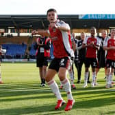 Sonny Cox leads the celebrations for Exeter City