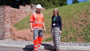 Collapsed wall in Countess Wear rebuilt with wildflowers