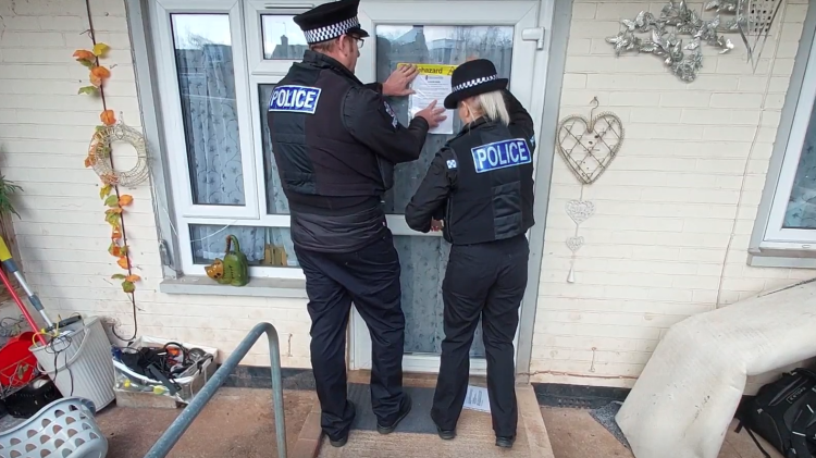 Police officers issuing the closure order
