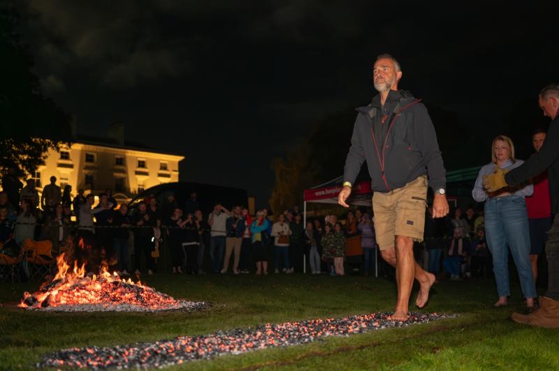 Hospiscare's Operations Director Wayne Gale striding along the coals