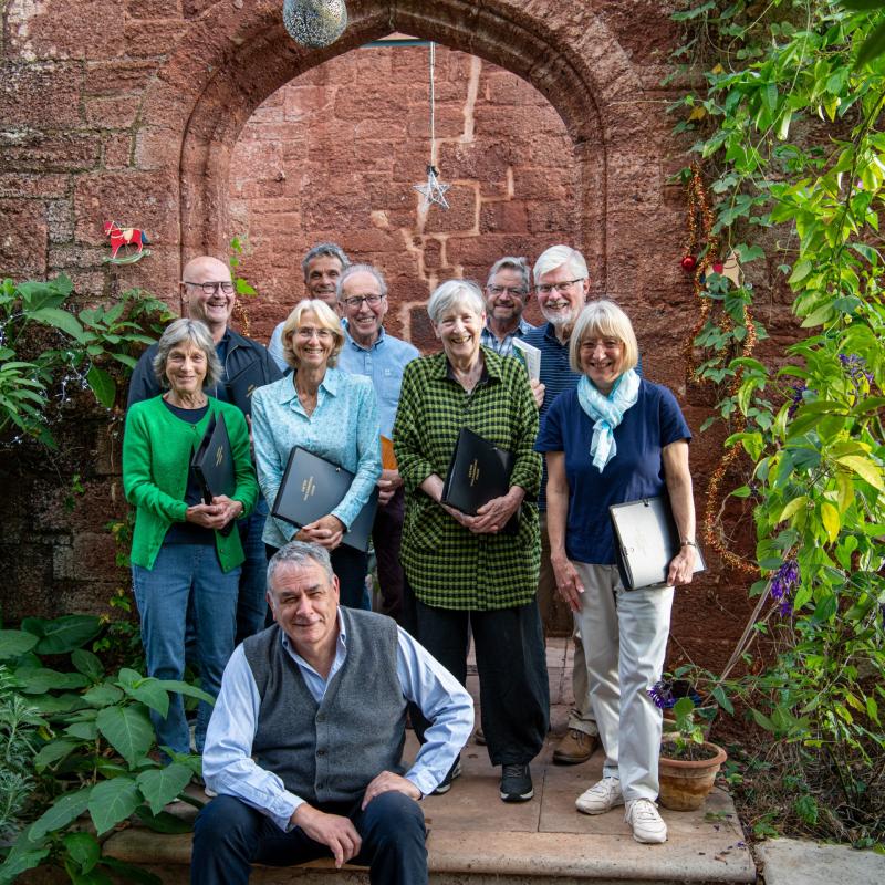 Dr Todd Gray getting into the festive spirit with some of the choir’s members Image:  Martin Stubbings