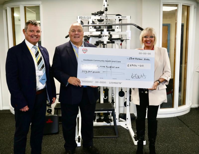  Exeter Chiefs Foundation trustees David Bird (left) and Keiron Northcott (centre) present Westbank CEO Sarah Hicks with a cheque for the Equalizer training apparatus, Image: Sharon Goble
