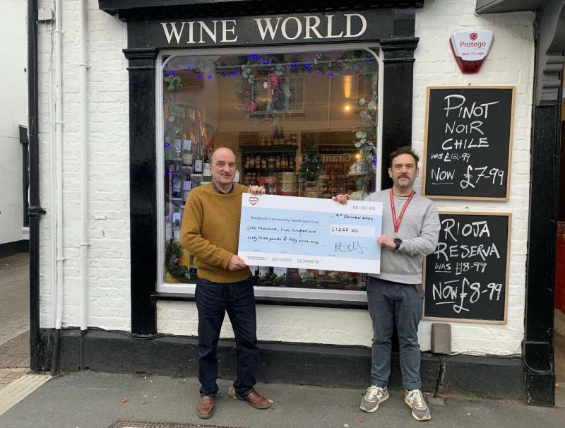 Patrick Agnew (right), Westbank's Devon Young Carers Service Manager, receives a cheque from Wine World's Julian Packer, Image: Westbank Community Health & Care