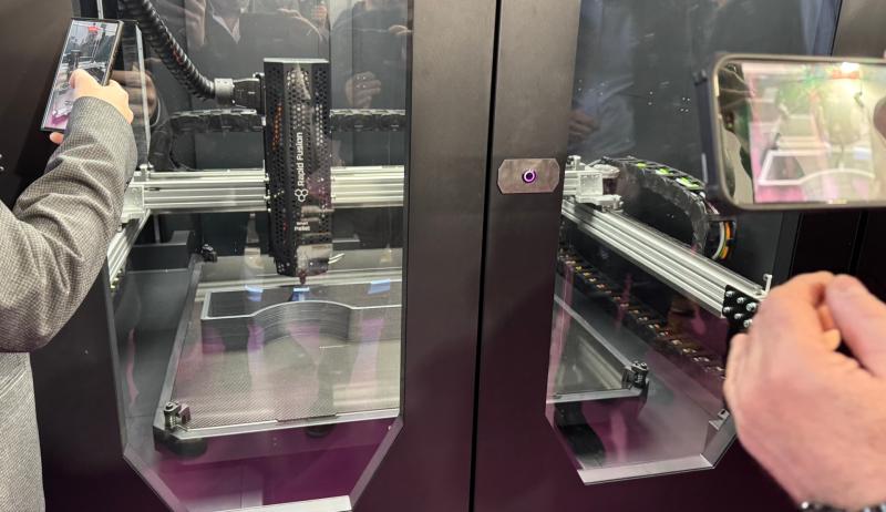 Guests watch the 3D-Printing machines in action