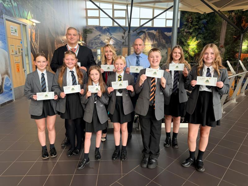 Torquay Academy project Steve Margetts, Thersa Pappin  and Ben Chadwick with students holding their &lsquo;Learning Legends&rsquo; vouchers.
