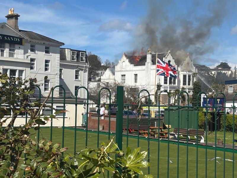 Flames rip through the roof of the empty Sherwood Hotel